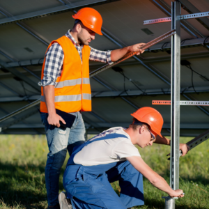 Solar construction technicians assembling racking on rental driven foundations